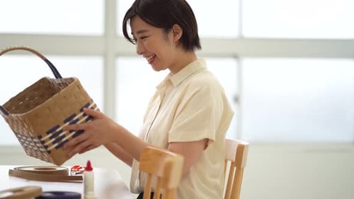Woman Smiling Proudly with Handmade Woven Basket
