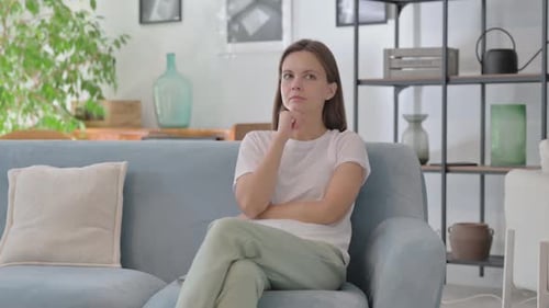 Woman Thinking on Couch in Living Room