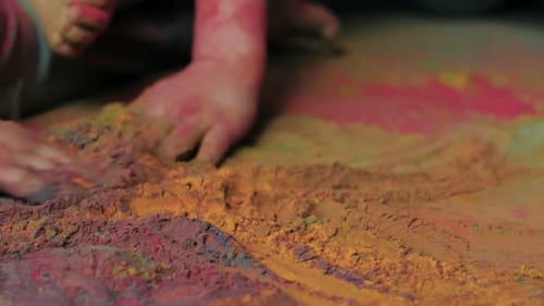 Hands Drawing Designs in Colorful Powder