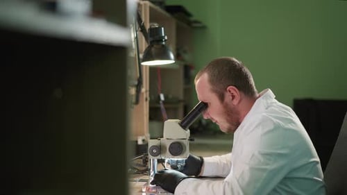Scientist Uses Microscope in Lab