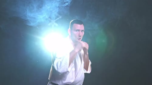 Man Demonstrating Karate Punches in a Studio