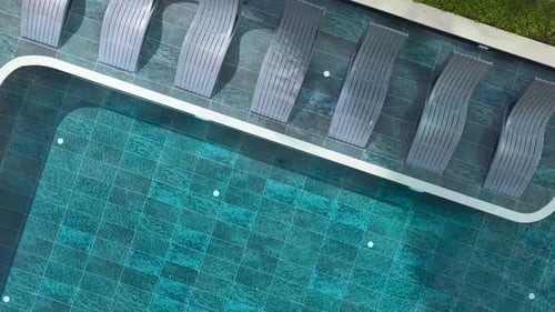 Aerial Video Modern Pool with Sunbeds and Clear Water View