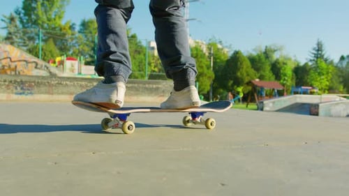 Skateboarder Does Tricks in Urban Skatepark
