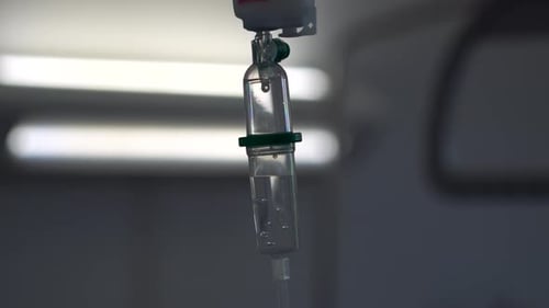 Set IV drip fluid. Intravenous therapy in a white hospital room. Intravenous line with iv drip stand