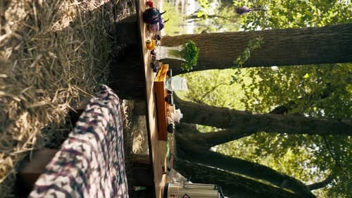 vertical video A wooden stand with bowls filled with water and cups of tea stands on table greens