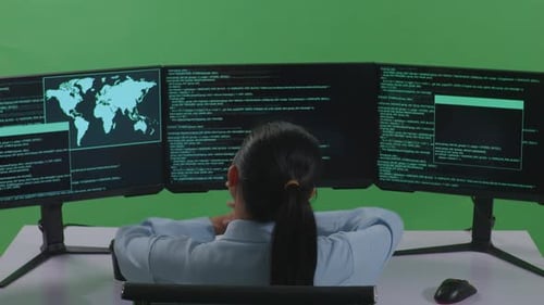Tired Asian Woman Stretching While Write Code With Multiple Computer Screens In Green Screen