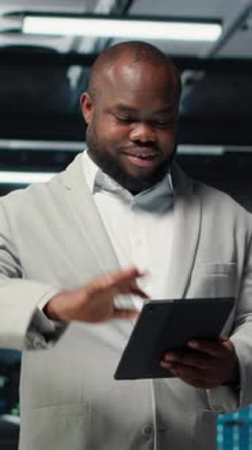 Vertical Video Smiling Admin Using Tablet in in Data Center Maintaining Infrastructure