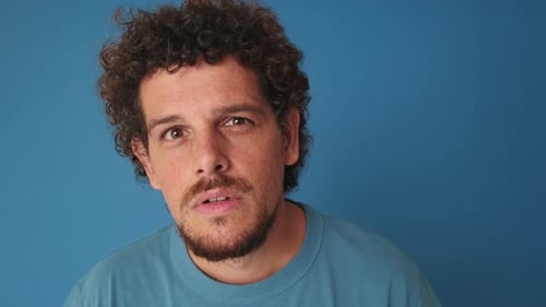 Close-up of surprised man looking at camera looking for something isolated on blue background