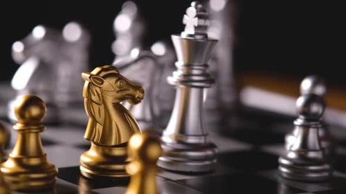 Close up shot hands of man playing golden and silver chess select focus shallow depth of field