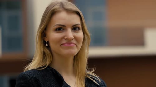 Blonde Woman Smiling in Urban Environment