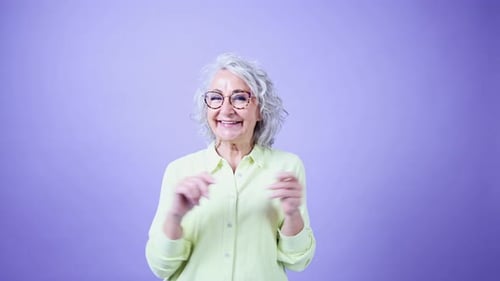 Joyful Senior Woman Dancing with Energetic Expression