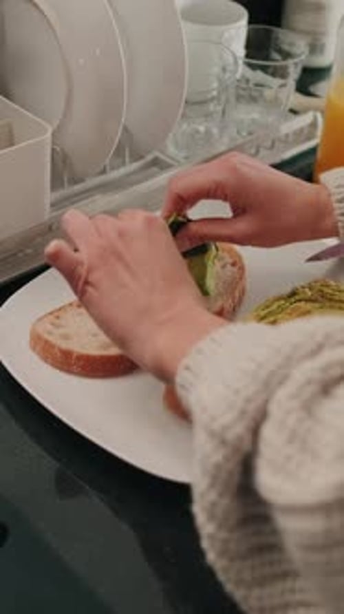 Hands Prepare Avocado Toast in a Kitchen
