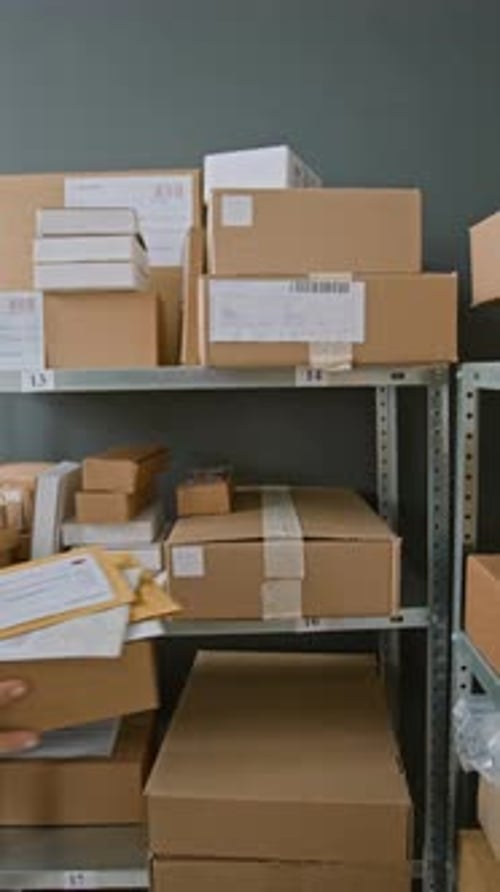 Female Pickup Outlet Employee Placing Package on Rack