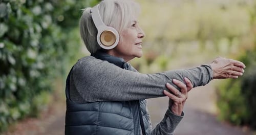 Old woman, stretching with headphones and fitness in park, running and cardio with wellness