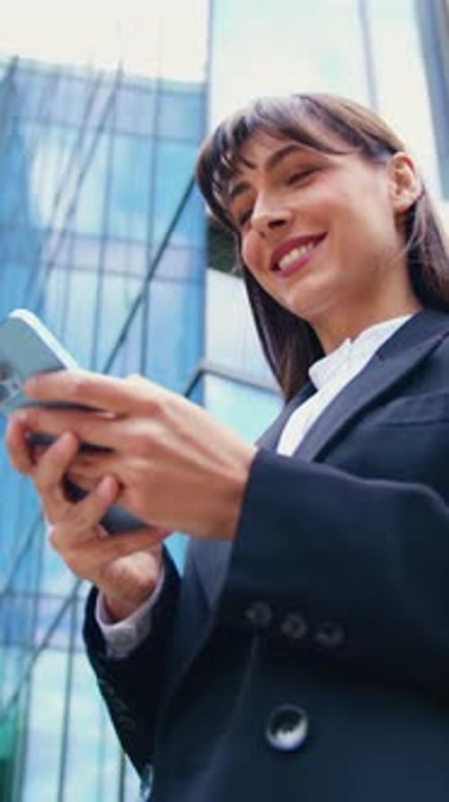 Business Woman Using Phone Near Modern Building