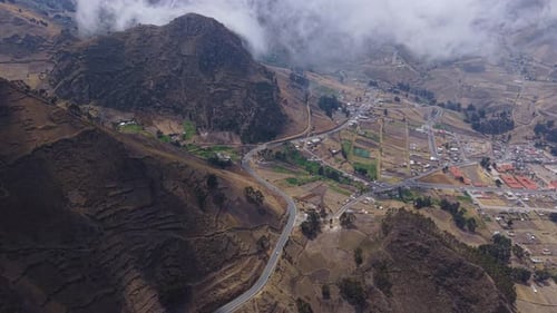 Misty Clouds Hovering Above Ecuadorian Andes Revealing Serpentine Mountain Road Winding Through