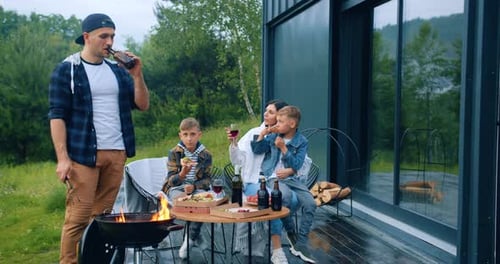 Family Enjoys Pizza and Grilling on a Summer Day