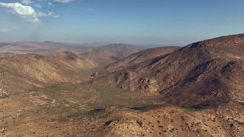 Panoramic aerial view of expansive rugged hilly desert landscape