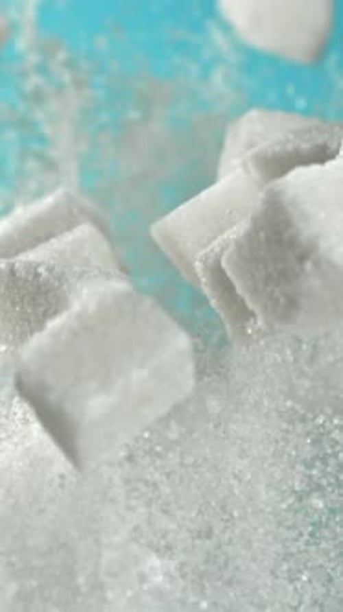 Cubes of Sugar Fly Up and Fall Down on a Blue Background Filmed on a Highspeed Camera at 1000 Fps