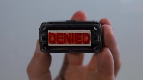 Denied Red Ink Stamp Impression on White Surface