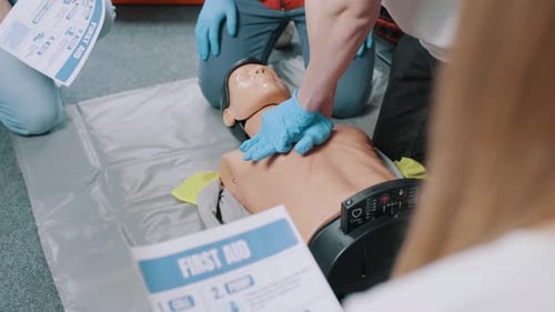 CPR Training on Medical Dummy in Bright Indoor Setting