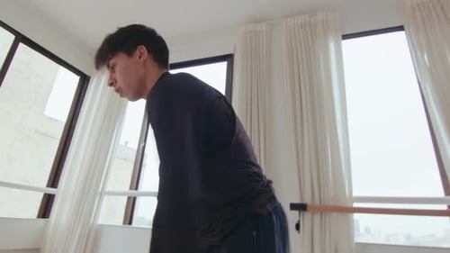 Young Artistic Man Dancing Contemporary Dance in Studio