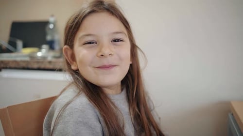 Smiling Young Girl Sitting Indoors Portrait Close-Up