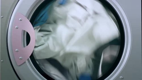 Drying Laundry Clothes. Closeup View Of Drying Machine. Closeup Of Industry Washing Machine. Unif...