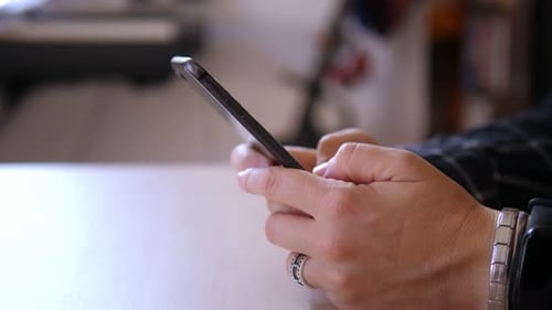 Typing on Mobile Phone Indoors Close Up