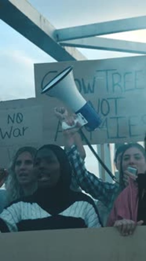 People Protest and Chant at a Rally