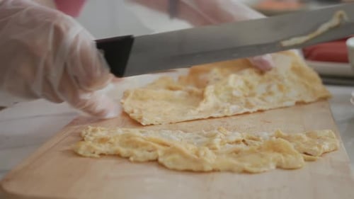 Slicing a Egg Omelet on a Cutting Board