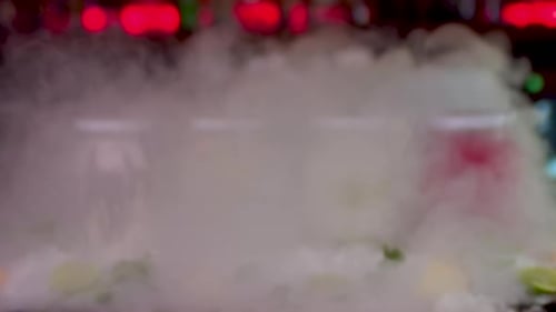 Smoke Reveal Of Colourful Frozen Smoothie Jars On Bar. Dolly Forward, Slow Motion