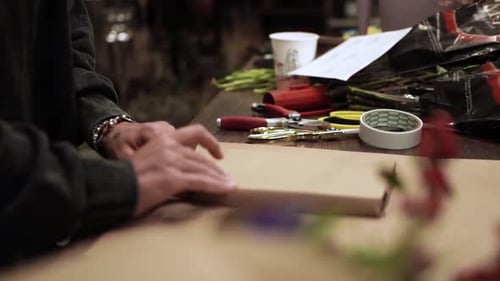 Florist Wrapping Flowers on Craft Paper