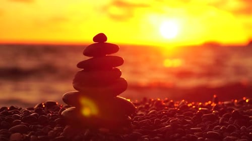 Balanced Rock Pyramid on Pebbles Beach Sunny Day and Clear Sky at Sunset