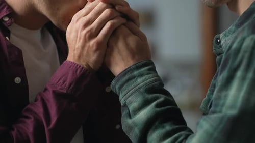 Men Holding Hands with Affection and Care