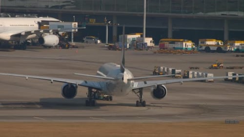 Airplane Stationary on Airport Runway During Daytime