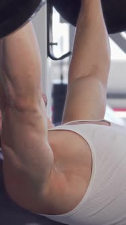 Man Bench-Pressing Barbell at the Gym