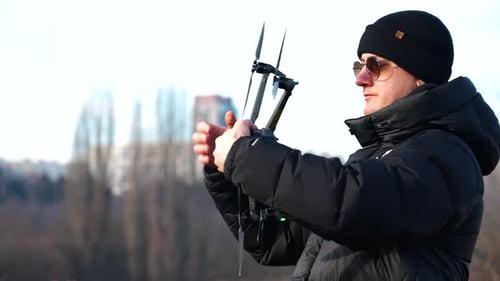 Person hold drone sideways and rotate around it axis to calibrate system