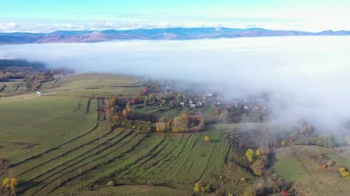 Aerial View of Autumn Clouds Above Countryside Pasture. Flying Over Hills with Drone