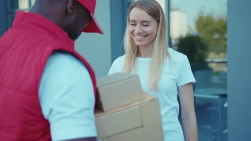 On Street African American Delivery Man Hold Package Woman Client Paying By Phone for Parcel