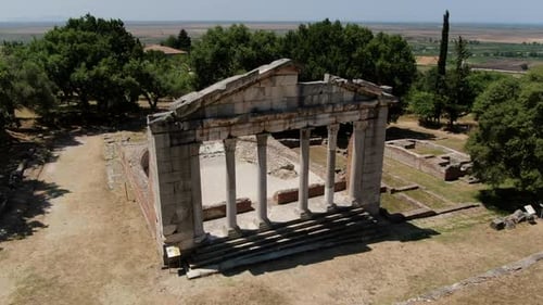 Cinematic aerial shot in orbit and in the archaeological park of Apollonia where the structure of th