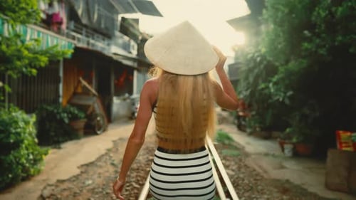 Beautiful Blonde Woman Traveling in Vietnam Back View of Strolling Lady in Hat Traditional Conical