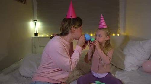 Mother and Daughter Celebrate Birthday on Bed