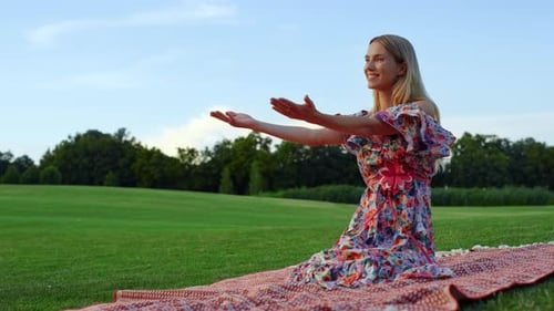 Smiling Mother Hugging Daughter in Park at Sunset. Young Woman Kissing Adorable