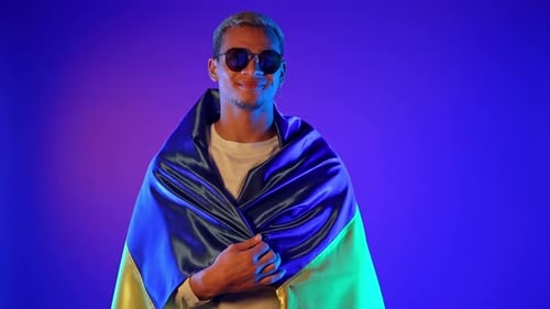 Smiling Man with Flag in Studio