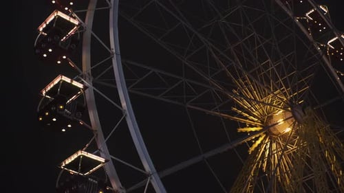 Bright Ferris Wheel Turning Spinning at Night at a Amusement Park