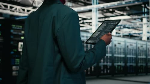 Close Up of Data Center Programmer Using Tablet App to Write Code