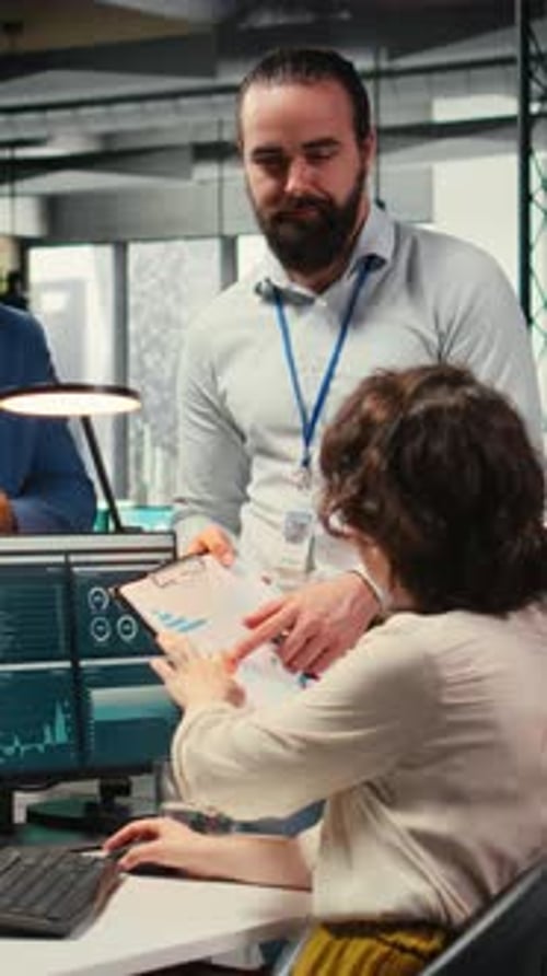 Vertical Video Multiethnic Work Team Consulting Each Other in Completing Monthly Reports