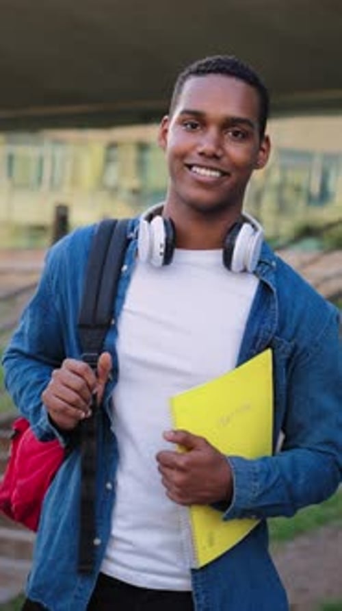 Vertical Ambitious and Friendly African American Male Student Standing Proudly on His University