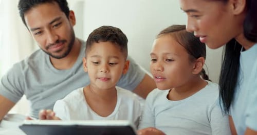 Family Uses Tablet Together Indoors in Daytime